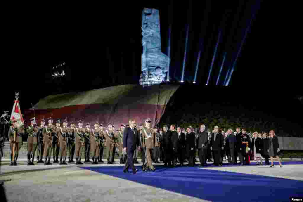 Poland's President Bronislaw Komorowski (front L) and officials attend a ceremony to commemorate the anniversary of the end of the World War II, at the WWII Westerplatte Memorial in Gdansk, north Poland, May 8, 2015.