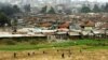 Children play on the way home after school in Pumwani slums near Kenya's capital Nairobi, seen in the background, September 14, 2006.