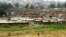 Children play on the way home after school in Pumwani slums near Kenya's capital Nairobi, seen in the background, September 14, 2006.