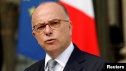 FILE - French Interior Minister Bernard Cazeneuve speaks about fires that hit the south of France, in the Elysee Palace courtyard at the end of a defense council in Paris, France, August 11, 2016. 