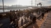 FILE - Residents of northeastern Syria walk at the Tishrin Dam to join a sit-in demanding an end to the war in the region in Aleppo's countryside, Syria, Jan. 8, 2025.