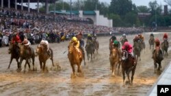 Luis Saez rides Maximum Security across the finish line first followed by Flavien Prat on Country House during the 145th running of the Kentucky Derby horse race at Churchill Downs, May 4, 2019, in Louisville, Ky.