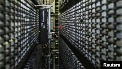 A robotic tape library used for mass storage of digital data is pictured at the Konrad-Zuse Centre for applied mathematics and computer science (ZIB), in Berlin, August 13, 2013. 