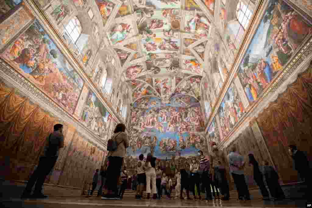 Visitors admire the Sistine Chapel as the Vatican Museum reopened, in Rome, Italy.