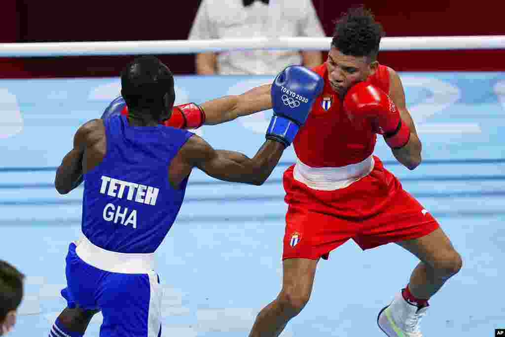 Cuba&#39;s Yosbany Vetia, right, exchanges punches with Ghana&#39;s Tettah Sulemanu during their men&#39;s flyweight 52-kg boxing match at the 2020 Summer Olympics, Saturday, July 31, 2021, in Tokyo, Japan. (AP Photo/Frank Franklin II)