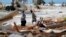 Christina Amanda, right, and Connie Huff, look for their possessions at the site of their destroyed home in the aftermath of Hurricane Michael in Mexico Beach, Fla., Oct. 17, 2018.