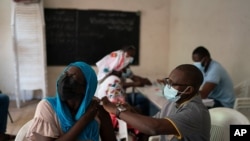 A health worker administers a dose of Janssen Johnson & Johnson COVID-19 vaccine at Dakar's Medina neighborhood, Senegal, July 28, 2021. 