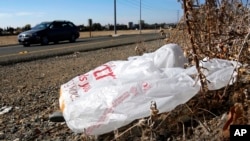 FILE - A plastic bag sits along a roadside in Sacramento, California, Oct. 25, 2013.