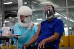 A health worker administers the COVID-19 vaccine at the Central Vaccination Center in Bangkok, Thailand, July 22, 2021.