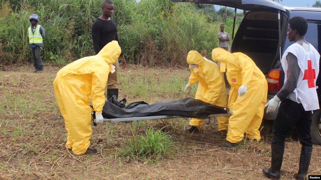 FILE - Health workers carry the body of an Ebola virus victim in the Waterloo district of Freetown, Oct. 21, 2014. 