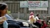 Pengendara motor melintas di depan spanduk bertuliskan penolakan terhadap kaum LGBT di kawasan Cigondewah Kaler, Bandung, Jawa Barat, pada 27 Januari 2016. (Foto: Reuters/Agus Bebeng)