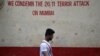 A man walks past a wall riddled with bullet holes opposite to the Nariman House, one of the targets of the November 26, 2008 attacks, after the renaming ceremony of Nariman House as Nariman Light House in Mumbai, India, November 25, 2018.