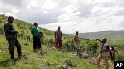 FILE - Cleous Bwambale, right, of United Nations High Commissioner for Refugees talks to members of the Nakivale Green Environment Association during a field visit at Nakivale Refugee Settlement in Mbarara, Uganda, on December 5, 2023.