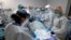 Dr. Joseph Varon, top with JV on shield, leads a team as they tried without success to save the life of a patient inside the Coronavirus Unit at United Memorial Medical Center, July 6, 2020, in Houston. 