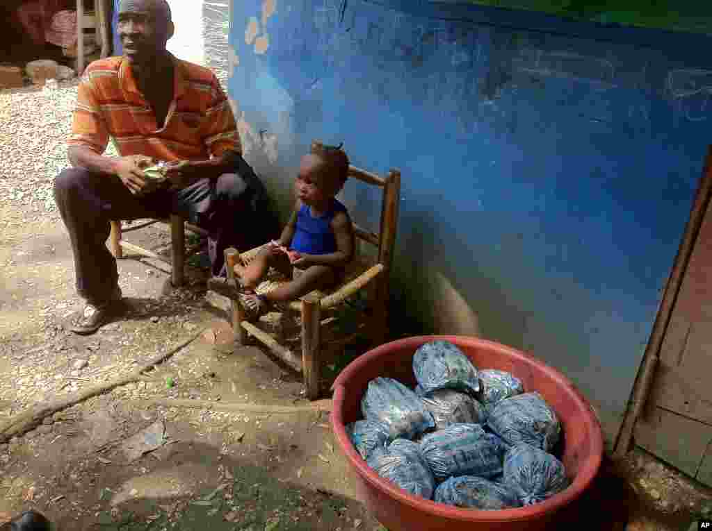 Man sells charcoal and watches his baby son