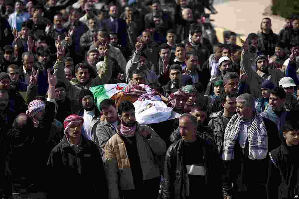 People carry Abdulaziz Abu Ahmed Khrer during his funeral in Idlib. (AP)