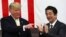 U.S. President Donald Trump, left, and Japan's Prime Minister Shinzo Abe react during delivering a speech to Japanese and U.S. troops as they aboard Japan Maritime Self-Defense Force's (JMSDF) helicopter carrier DDH-184 Kaga at JMSDF Yokosuka base in Yokosuka,Tuesday, May 28,2019