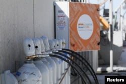 Tanks containing captured carbon dioxide are seen near a CarbonCure reclaimer unit that controls the flow of CO2 in San Jose, California, U.S. February 1, 2023. (REUTERS/Nathan Frandino)