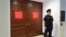 In this July 25, 2017 photo, a U.S. Capitol Police office stands guard outside a secure area in the basement of the Capitol in Washington, where the House Intelligence Committee has been conducting interviews. 