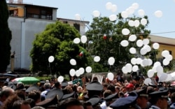 White balloons are released as the coffin of slain Carabinieri military police officer Mario Cerciello Rega is carried by Carabinieri officers outside Santa Croce church, during his funeral in his hometown Somma Vesuviana, Italy, July 29, 2019.
