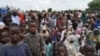 FILE - Civilians who fled their homes following an attack by Islamist militants in Bama, take refuge at a school in Maiduguri, Nigeria, September 2014. 