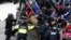 Pro-Trump protesters tear down a barricade as they clash with Capitol Police during a rally to contest the certification of the 2020 U.S. presidential election results by the U.S. Congress, at the U.S. Capitol Building in Washington, Jan. 6, 2021.