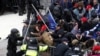 Pro-Trump protesters tear down a barricade as they clash with Capitol Police during a rally to contest the certification of the 2020 U.S. presidential election results by the U.S. Congress, at the U.S. Capitol Building in Washington, Jan. 6, 2021.