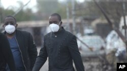 Zimbabwean main opposition leader Nelson Chamisa, right, accompanied by his lawyer Thabani Mpofu leave Harare remand prison after visiting prominent journalist Hopwell Chin'ono in Harare, Aug, 4, 2020.