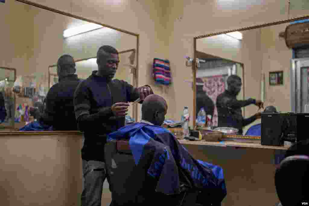 A barbershop in Hadayek El-Maadi, a neighborhood of Cairo where many African refugees find affordable housing and can start businesses that serve their community. Many African refugees start their businesses because they face discrimination in Egypt.