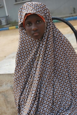 FILE - This Dec. 24, 2014, photo shows Zahra'u Babangida, a 13 -year-old girl arrested with explosives strapped to her body, in Kano, Nigeria.