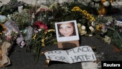 Flowers and a photo of car ramming victim Heather Heyer lie at a makeshift memoriall in Charlottesville, Virginia, Aug. 13, 2017.