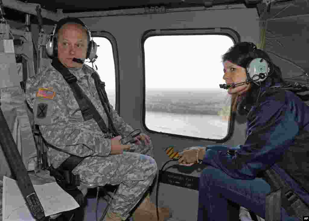 South Carolina Gov. Nikki Haley, right, and Major Gen. Bob Livingston, left, view flood damage from a helicopter in Columbia, S.C., Oct. 6, 2015.