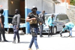 Members of the Haitian police and forensics look for evidence outside of the presidential residence in Port-au-Prince, Haiti, July 7, 2021.