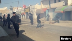 Riot police officers clean up after clashing with protesters protesting over jobs and a lack of development, in Ben Guerdane, Tunisia, Jan. 12, 2017.