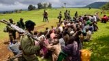 Congolese soldiers guard suspected M23 rebel fighters who surrendered in Chanzo village in the Rutshuru territory near the eastern town of Goma. Democratic Republic of Congo's M23 rebel group called an end to a 20-month revolt after the army captured its last hilltop strongholds, raising hopes for peace in a region where millions have died in nearly two decades of violence.