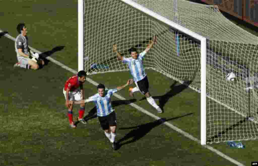 Argentina's Gonzalo Higuain and Sergio Aguero celebrate after scoring during the World Cup group B soccer match between Argentina and South Korea at Soccer City in Johannesburg, South Africa, Thursday, June 17, 2010. Argentina won 4-1. (AP Photo/Marcio 