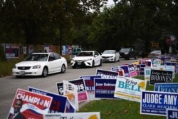 FILE - A line of cars drive in for an event encouraging community members to vote in the upcoming presidential election at an early voting site in Houston, Texas, U.S., Oct. 25, 2020.