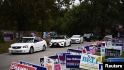 FILE - A line of cars drive in for an event encouraging community members to vote in the upcoming presidential election at an early voting site in Houston, Texas, U.S., Oct. 25, 2020.