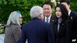 South Korea's President Yoon Suk Yeol and his wife Kim Keon Hee talk with Judy Wade, the niece of Medal of Honor recipient Cpl. Luther Story, and her husband Joseph Wade, as they visit the Korean War Veterans Memorial in Washington, April 25, 2023.