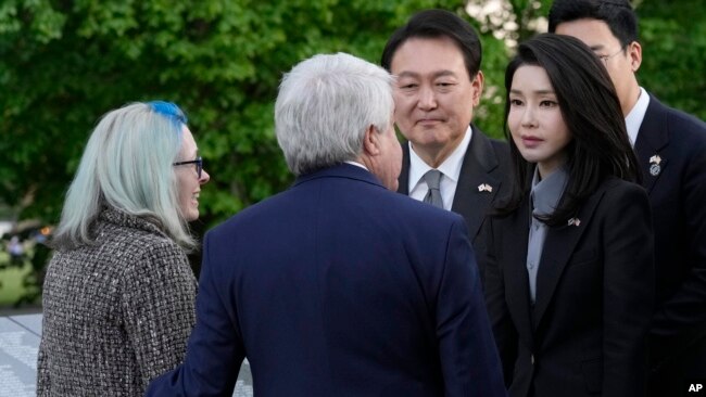 South Korea's President Yoon Suk Yeol and his wife Kim Keon Hee talk with Judy Wade, the niece of Medal of Honor recipient Cpl. Luther Story, and her husband Joseph Wade, as they visit the Korean War Veterans Memorial in Washington, April 25, 2023.