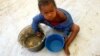 FILE - A Congolese child eats a meal at a UNHCR reception center in the Kyangwali refugee settlement camp, Uganda March 19, 2018. 