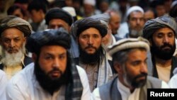 Afghan men attend a gathering launched by a political party ahead of an election campaign in Kabul, Sept. 3, 2013.