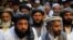 Afghan men attend a gathering launched by a political party ahead of an election campaign in Kabul, Sept. 3, 2013.