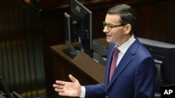 FILE - Poland's Prime Minister Mateusz Morawiecki gives his policy speech in the parliament in Warsaw, Poland.