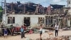 FILE - People inspect destroyed and damaged buildings after bombardments carried out by Myanmar's military in Lashio in Myanmar's northern Shan State on Sept. 24, 2024. 