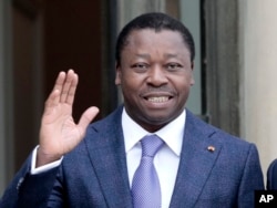 FILE—Togo's President Faure Gnassingbe waves before a working lunch at the Elysee Palace in Paris on April 9, 2021.