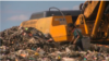 Men, women, and children dig through mountains of trash to earn money by collecting plastic and glass bottles for recycling.