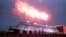 People watch 'float out' of newly built cruise ship Disney Dream at the Meyer shipyard in Papenburg, June 28, 2021.