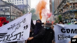 FILE - Anti-coup protesters shout slogans as they march during a protest in Pabedan township against the military junta, in Yangon, Myanmar, June 26, 2021.