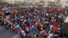 Cambodian garment workers and villagers block the main road demanding freedom for some worker activists who were arrested during Thursday's strike in Kambol village, on the outskirts of Phnom Penh, Cambodia, Thursday, Jan. 2, 2014. Troops have been used t